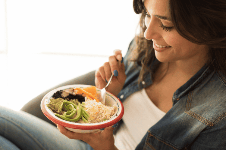 Close-up of a woman eating a vegan meal at home