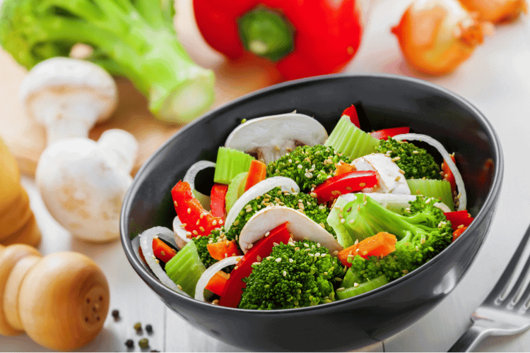 international healthy vegetarian salad in a grey bowl, closeup
