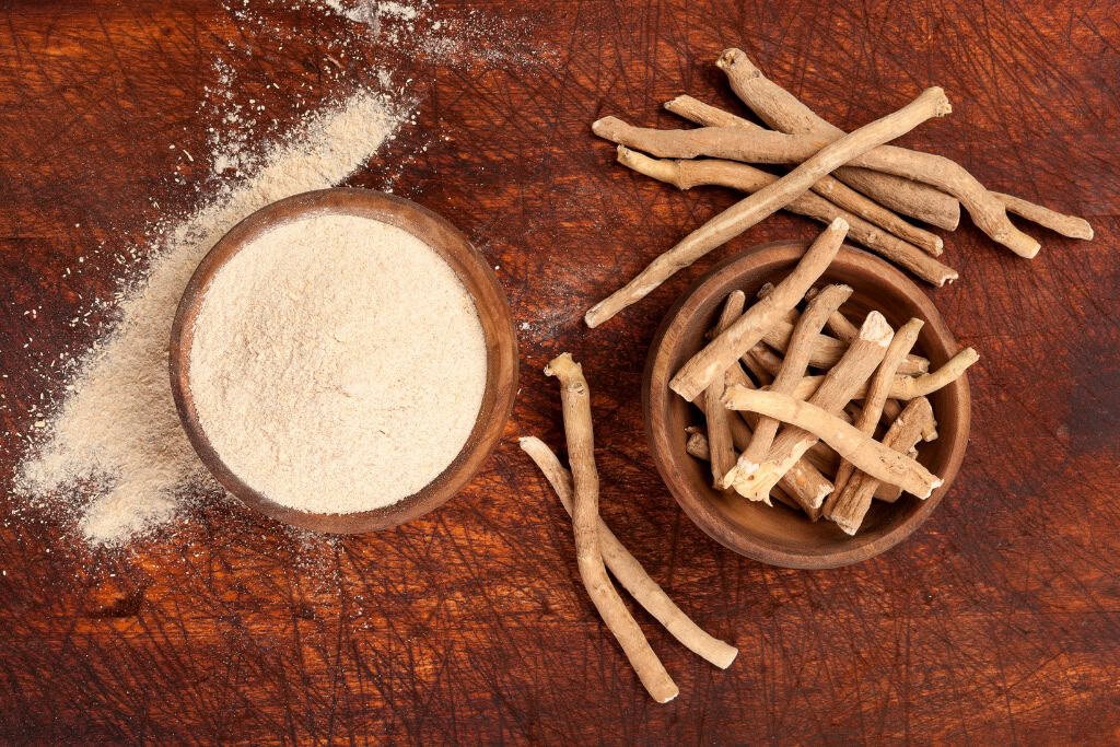 Ashwagandha root and Vegan powder on wood